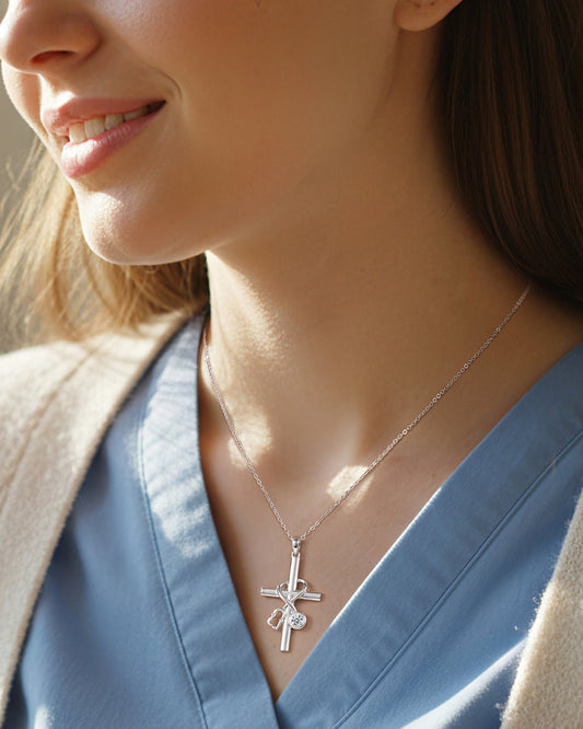 woman wearing sterling silver nurse cross necklace with stethoscope pendant